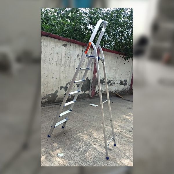 3 A step ladder placed on the ground next to a ladder.